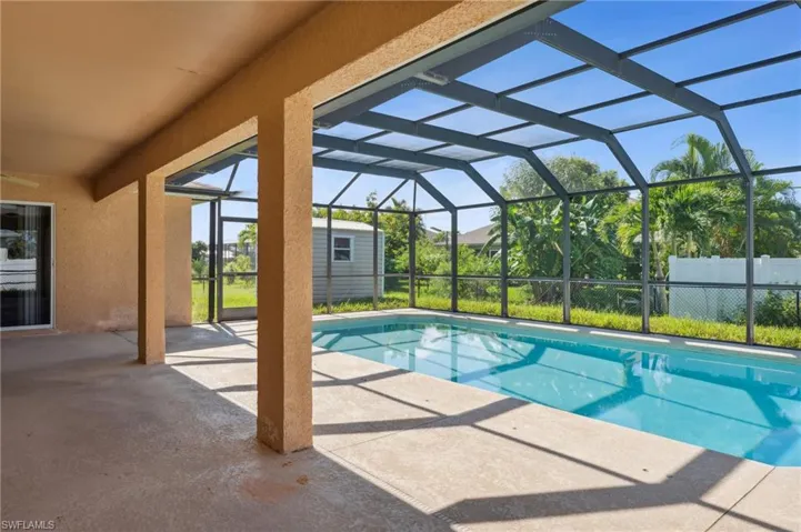 View of pool with a lanai and a patio