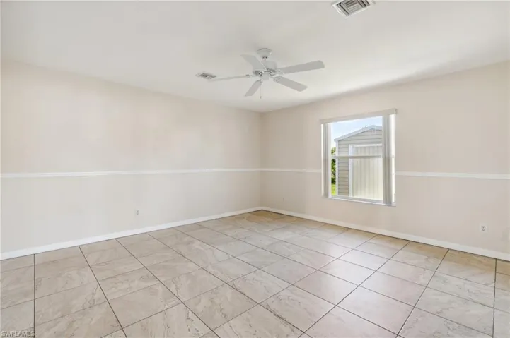Unfurnished room featuring ceiling fan
