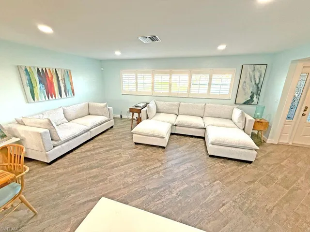 Living room featuring recessed lighting, healthy amount of natural light, and light wood-type flooring