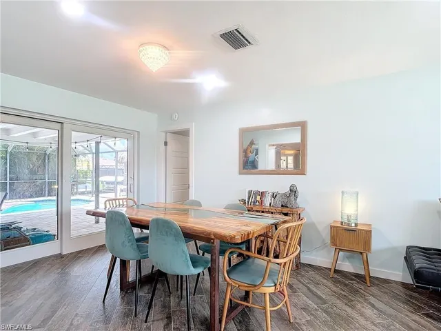 Dining space featuring dark wood-style flooring