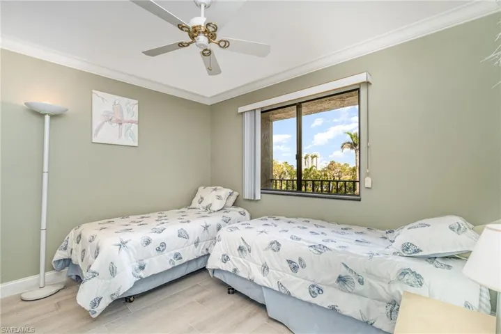 Guest Bedroom with tile floors and crown molding.