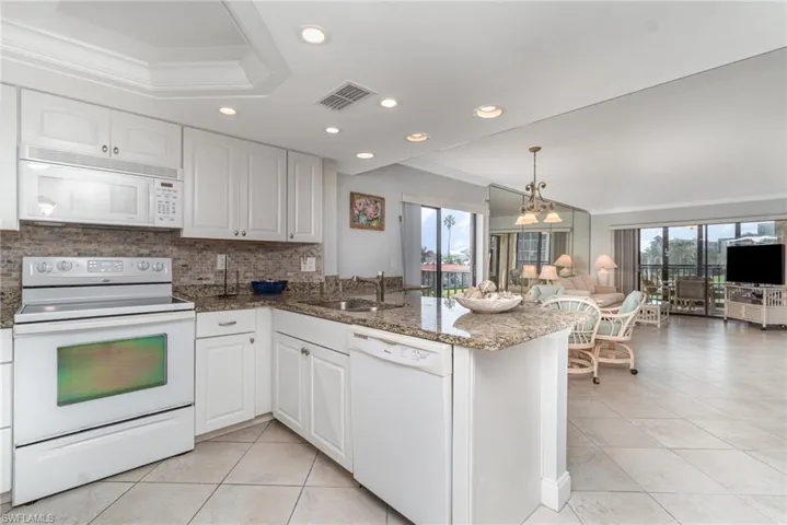 Kitchen with white appliances and lots of natural light
