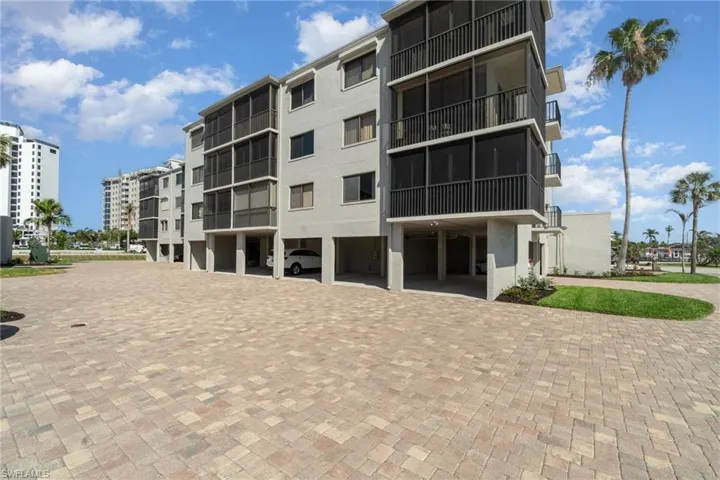 View of apartment building / complex featuring decorative driveway