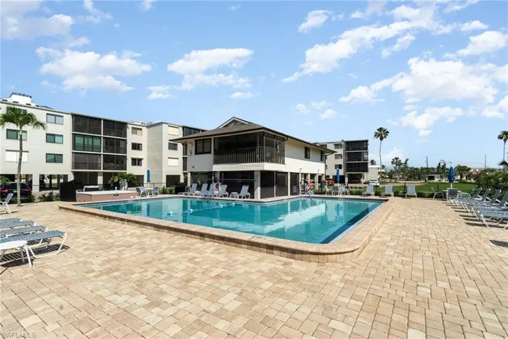 Community pool with a patio