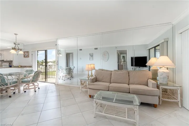 Living and dining room with lots of lights and two lanai's