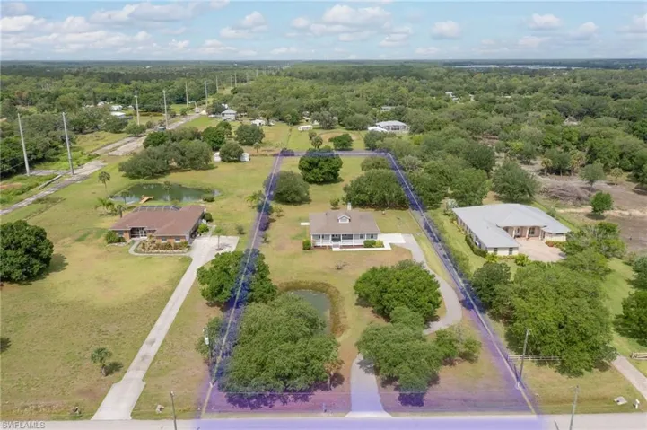 Aerial view of property's location featuring a forest, property boundaries highlighted, and a nearby body of water