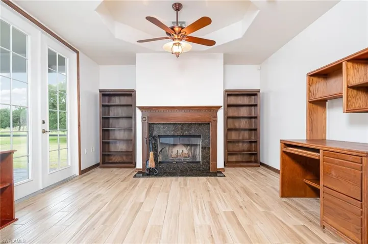 Family room  area with a ceiling fan, a  fireplace, and plenty of natural light