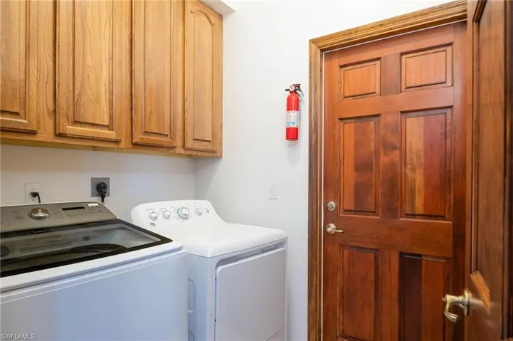 Laundry room with washer and dryer and cabinet space
