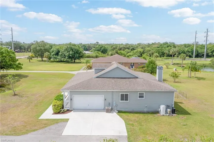 View of side of home with a garage and concrete driveway