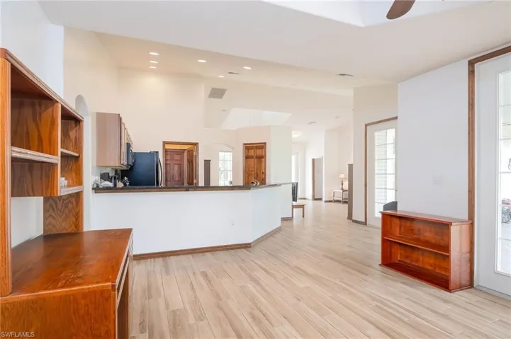 Family room featuring ceiling fan, lofted ceiling, and recessed lighting