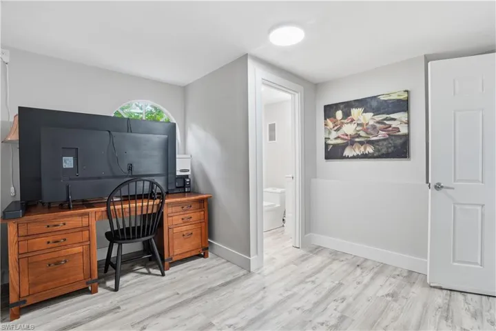 Light gray wood-finish flooring extending throughout the room