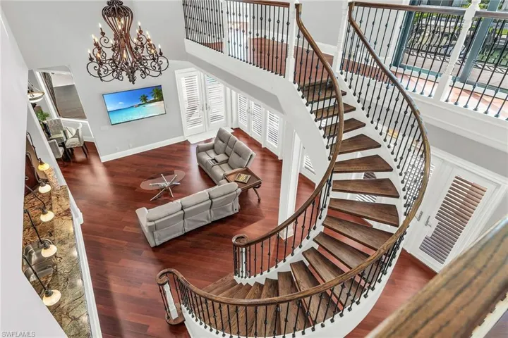 Custom Staircase featuring a towering ceiling, a chandelier
