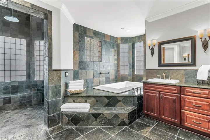 Primary Bathroom with dual sinks, SOK tub, walk in  tower shower