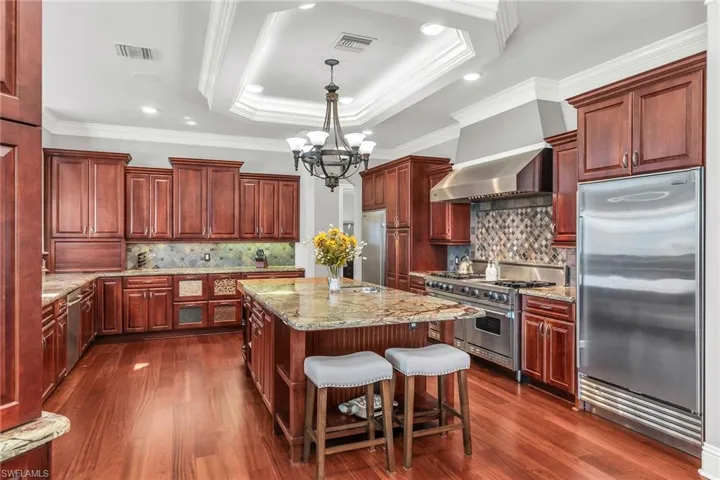 Chef Kitchen Viking and Sub Zero Appliances Gas Stove, center island, separate refrigerator and freezer.