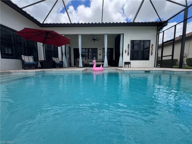 View of pool featuring a patio, a lanai, and ceiling fan