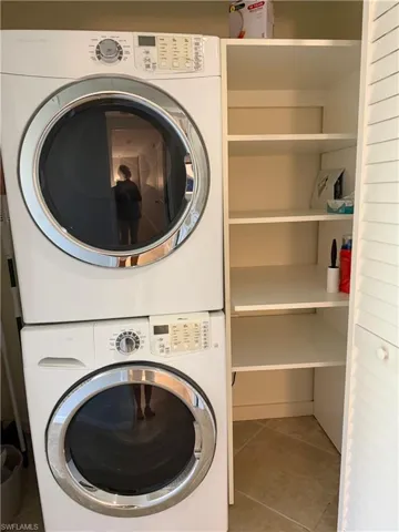 Stacked white washer and dryer units with chrome accents
