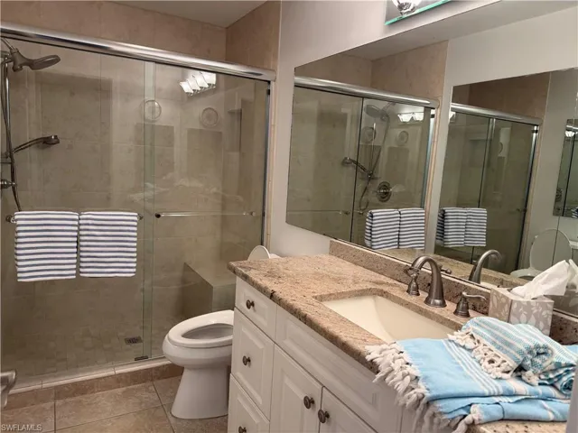 Glass-enclosed shower with a built-in bench