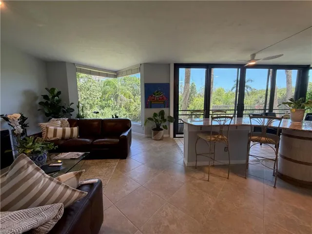 Expansive living area featuring large format tile flooring and abundant natural light
