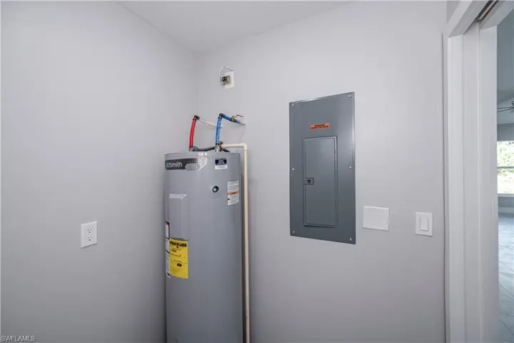 Utility room featuring electric water heater