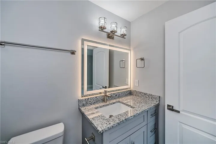 Bathroom with oversized vanity and toilet