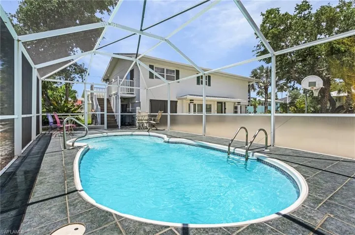 View of swimming pool with a lanai and a patio area