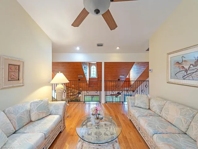 Living area with a ceiling fan and wood finished floors