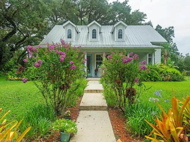 Cape cod-style house with a porch and a front yard