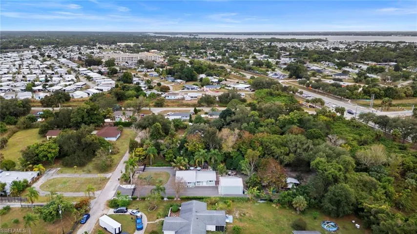 Aerial view of property's location with nearby suburban area