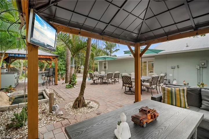 View of patio featuring a gazebo, outdoor dining area, and exterior kitchen