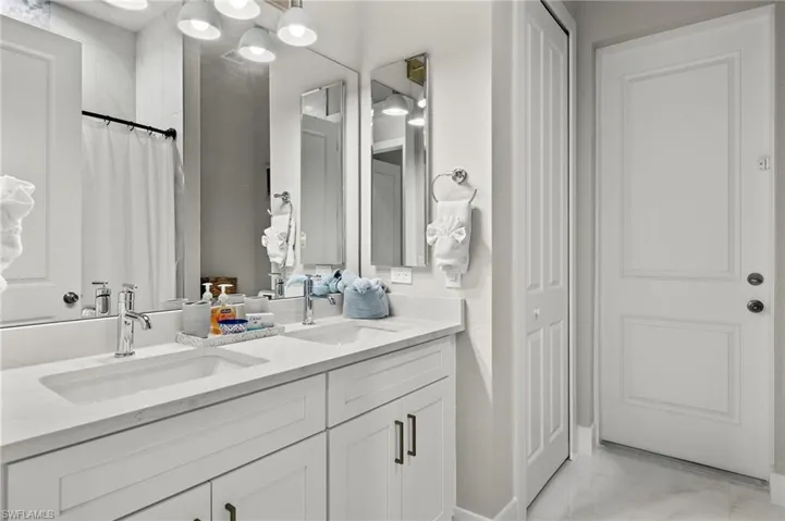Bathroom featuring vanity and a shower with shower curtain