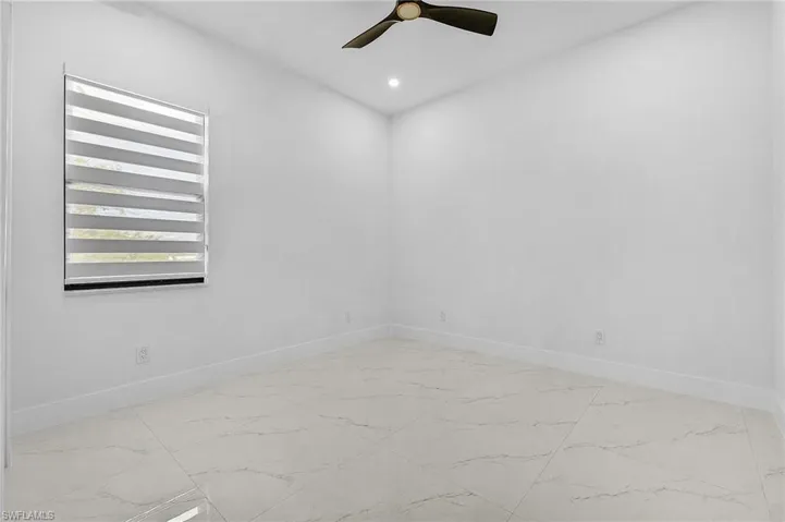 Spare room featuring recessed lighting, a ceiling fan, and baseboards