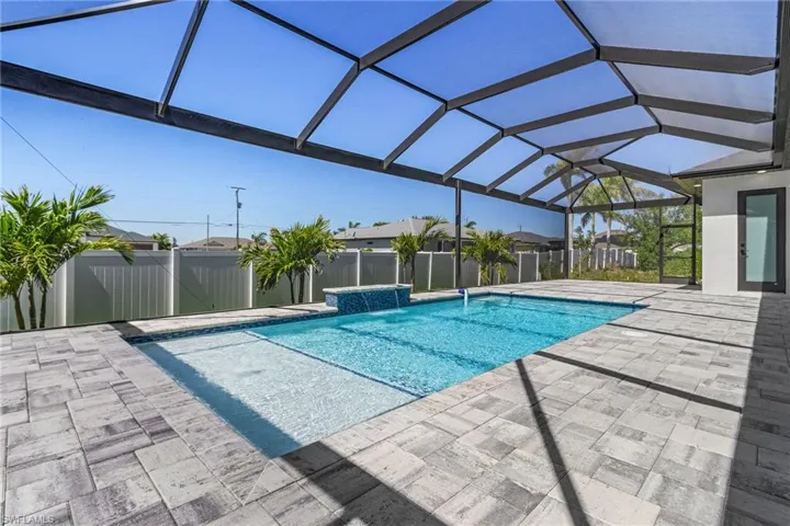 View of swimming pool with a patio area, a fenced in pool, a lanai, and fence