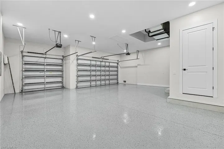 3-car garage with recessed lighting and storage closet