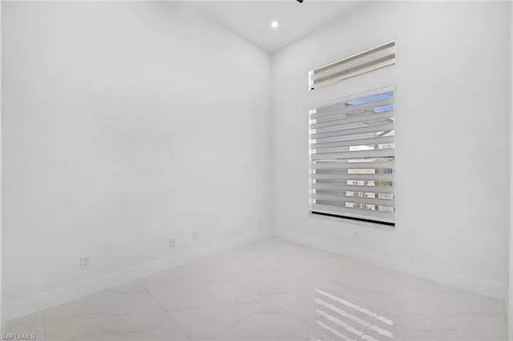 Unfurnished room featuring recessed lighting, marble finish floor, and baseboards