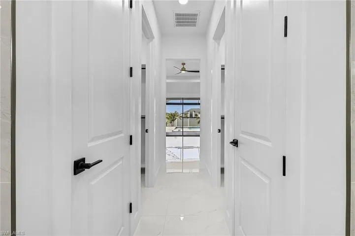 Corridor featuring visible vents and marble finish floor