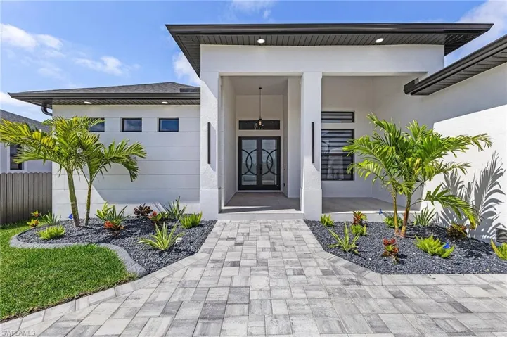 Property entrance featuring stucco siding