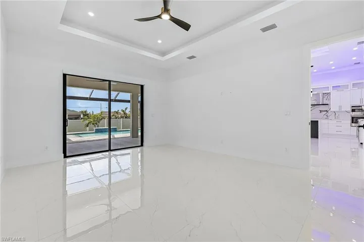 Unfurnished room featuring visible vents, baseboards, a tray ceiling, recessed lighting, and porcelain floor