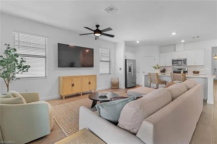 Living room featuring ceiling fan and light wood-type flooring