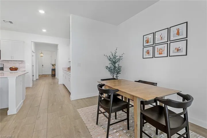 Dining space with light hardwood / wood-style floors
