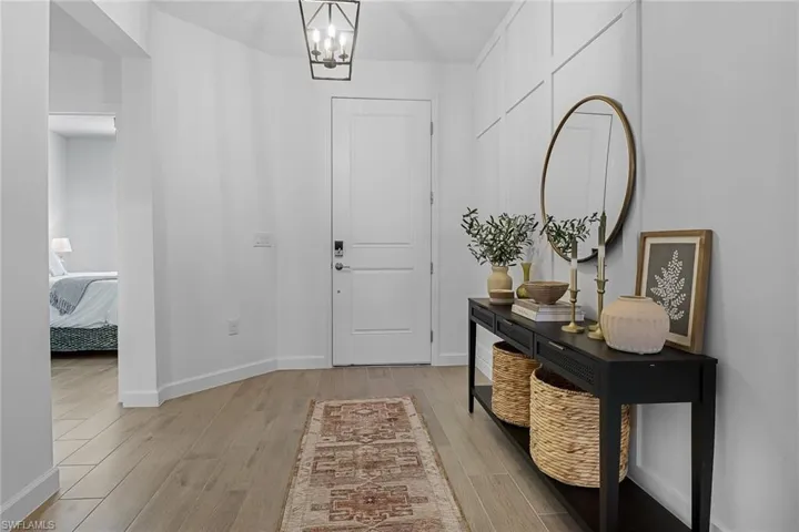 Entryway with a notable chandelier and light hardwood / wood-style floors
