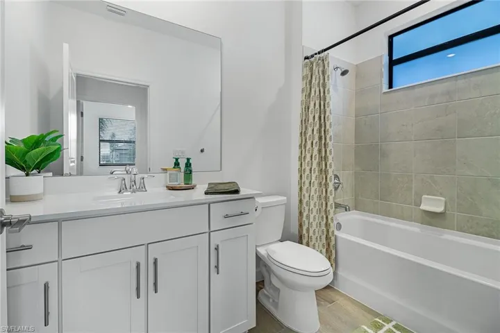 Full bathroom featuring vanity, toilet, and shower / tub combo