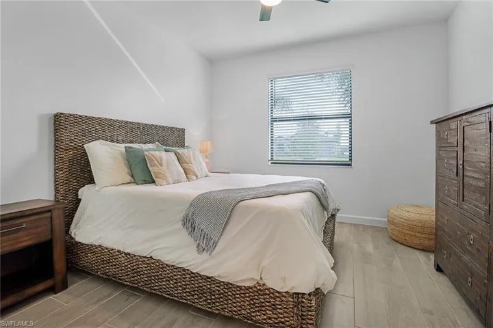 Bedroom with light hardwood / wood-style floors and ceiling fan