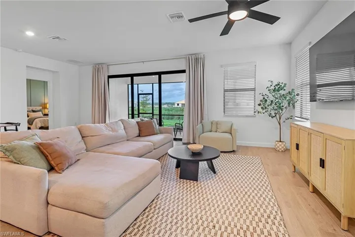 Living room featuring ceiling fan and light wood-type flooring