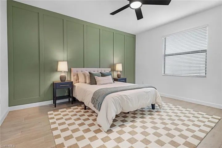 Bedroom featuring light hardwood / wood-style floors and ceiling fan