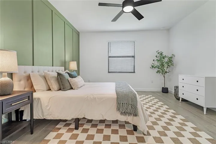 Bedroom featuring light hardwood / wood-style floors and ceiling fan