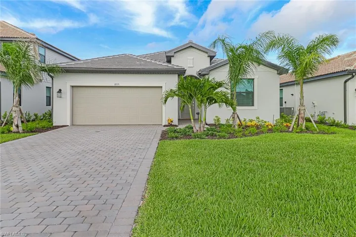 View of front of home featuring a garage and a front yard