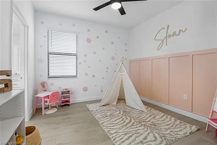 Playroom with ceiling fan and light hardwood / wood-style flooring