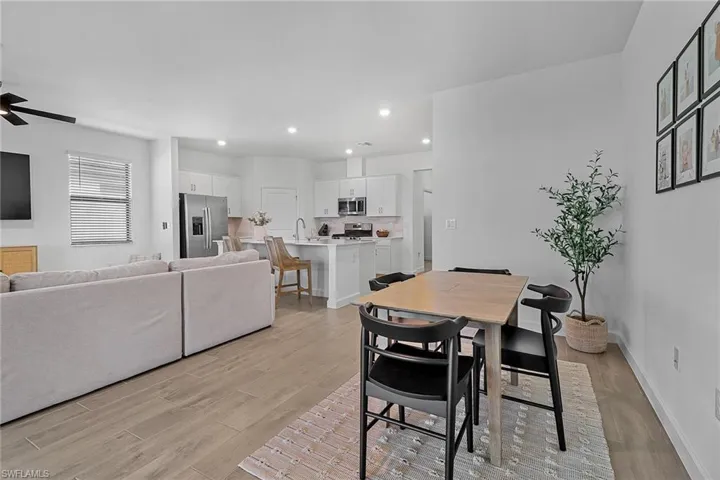 Dining area featuring ceiling fan, sink, and light hardwood / wood-style flooring