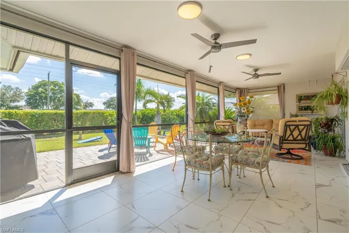 Sunroom / solarium featuring ceiling fan
