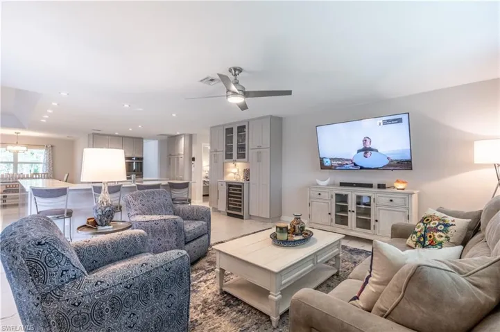Living room with ceiling fan and wine cooler
